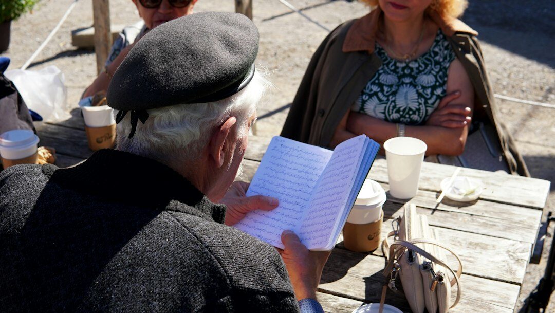 person writing in notebook