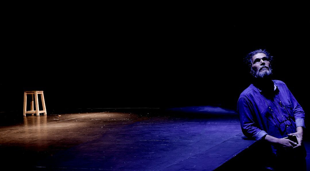 man standing tall on stage